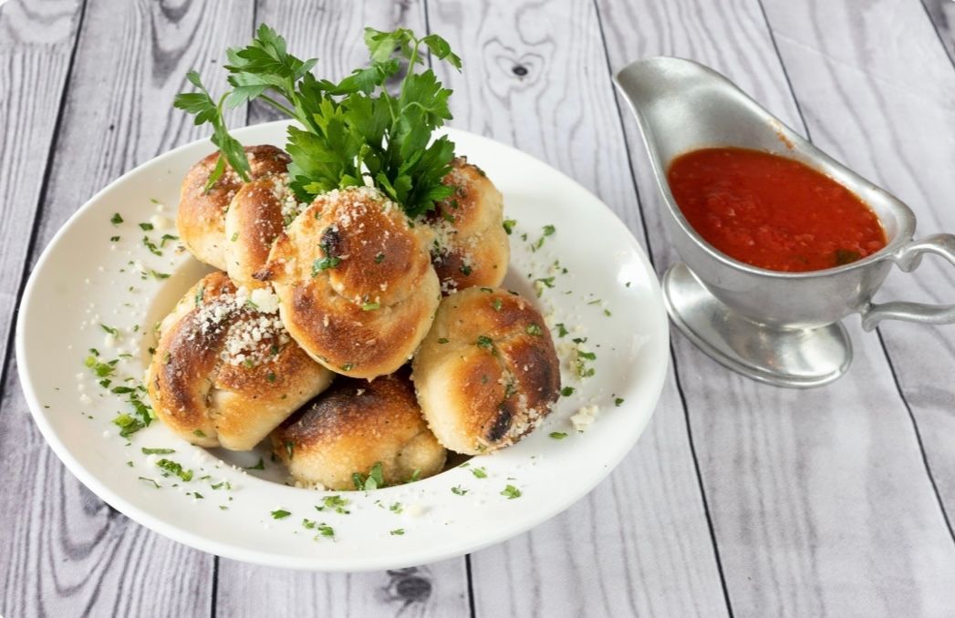 Famous Garlic Knots w/ 4 oz Marinara sauce